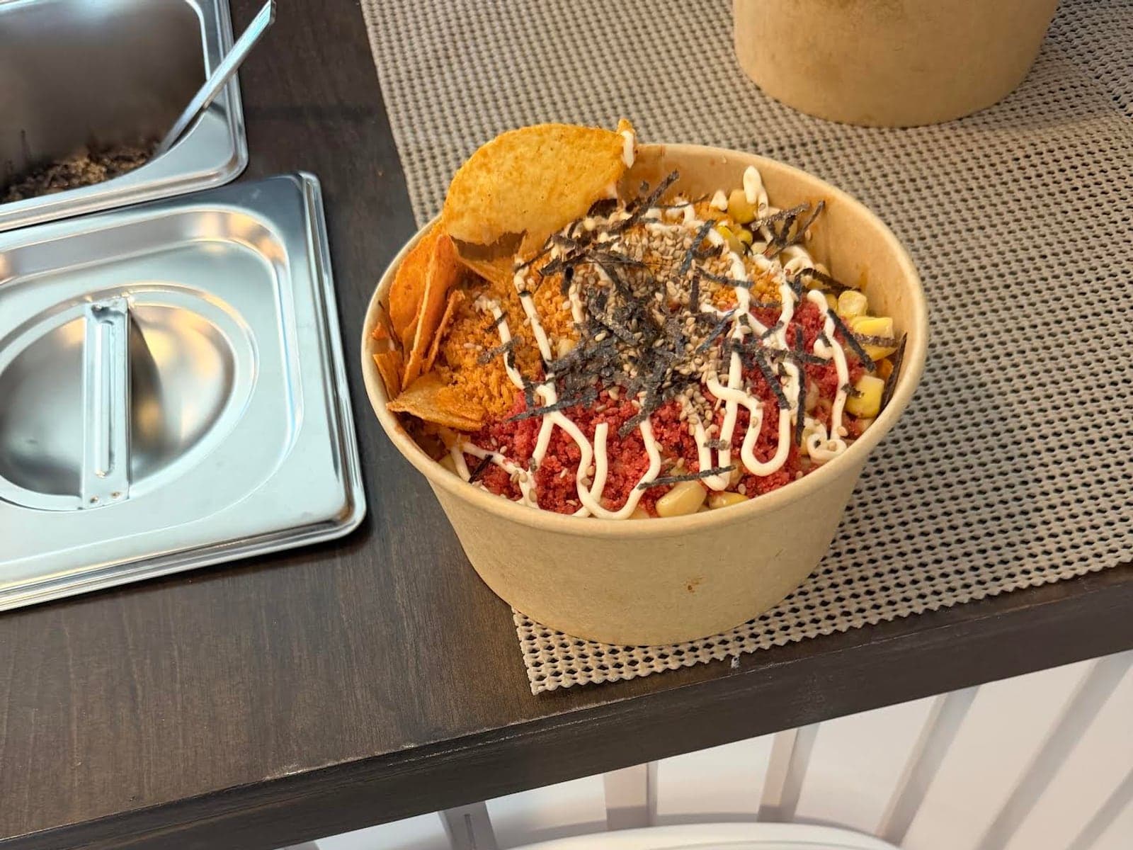 A finished bowl of SmileBites saucy ramen on the cart counter